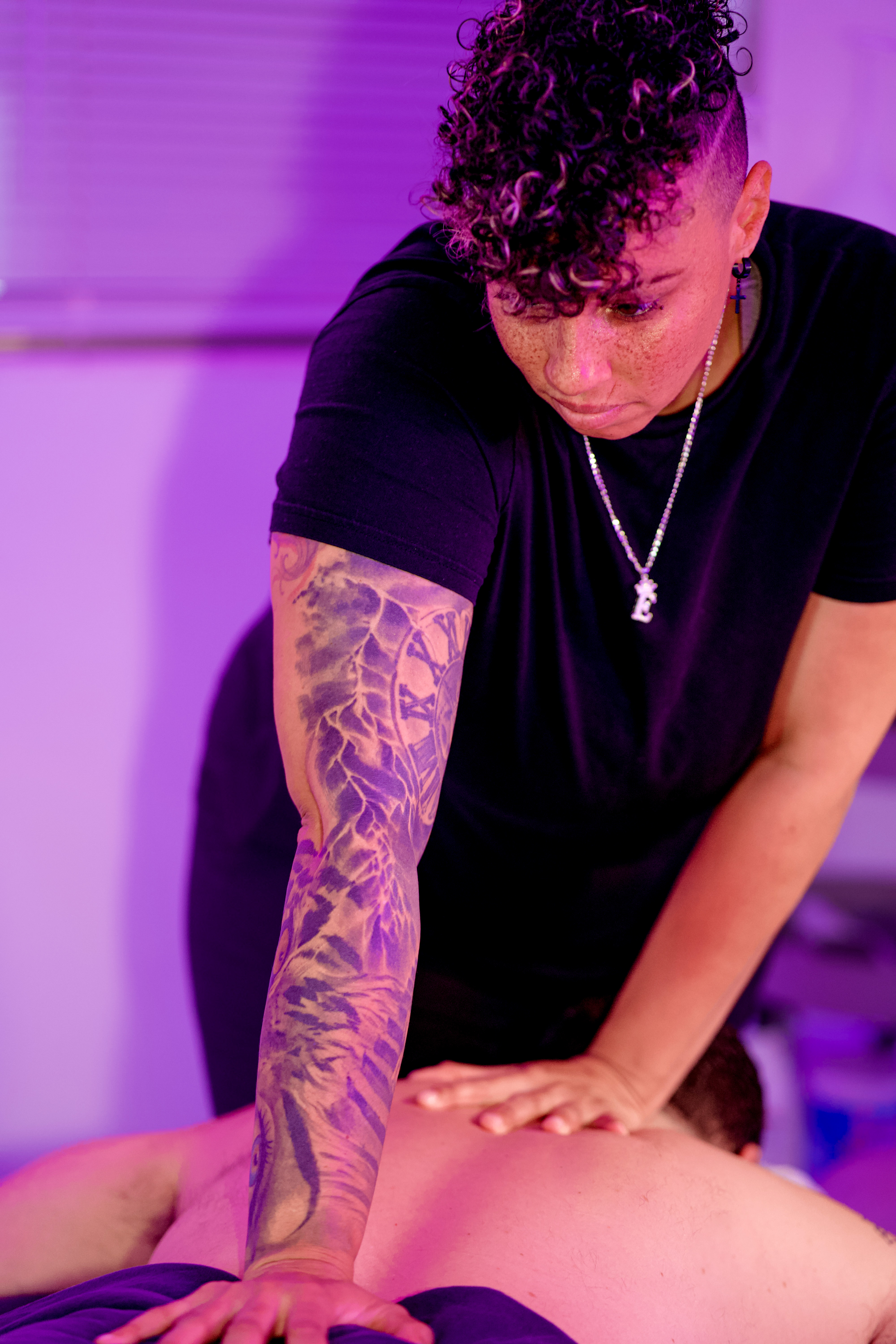 Massage therapist performing back massage